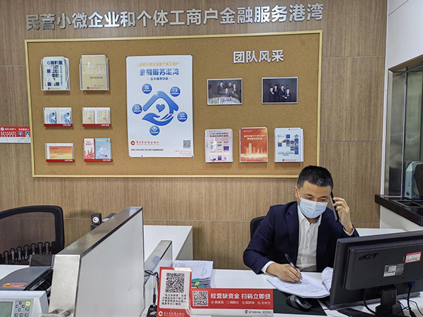 重慶農(nóng)商行江津分行客戶經(jīng)理王勝電話指導(dǎo)客戶通過“云簽約”辦理貸款手續(xù)。重慶農(nóng)商行供圖