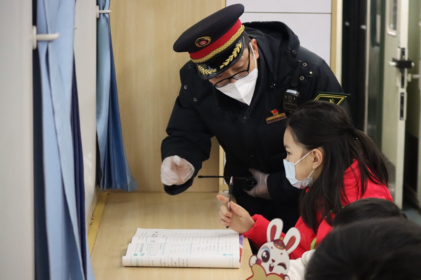 在5609次列車上，列車長王友為乘車的小學生講解車內服務設備。羅希雅攝
