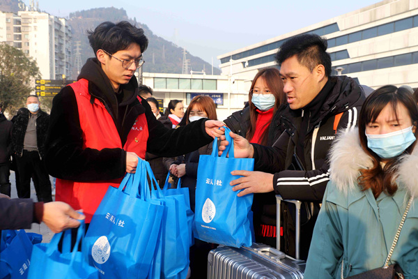 志愿者為務(wù)工人員送上返崗“大禮包”。李歆宇攝