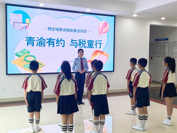 圖為在榮昌稅務法治教育基地，通過視頻連線，榮昌區(qū)稅務人員正帶領榮昌、青島兩地的學生們同步參觀基地。文明燕攝