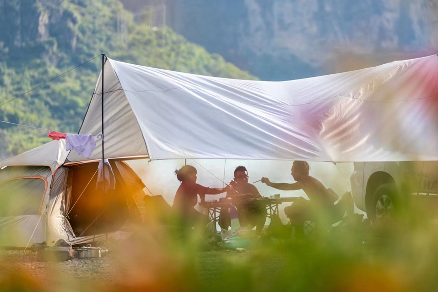 游客在頭渡鎮(zhèn)一露營基地避暑納涼。瞿明斌攝
