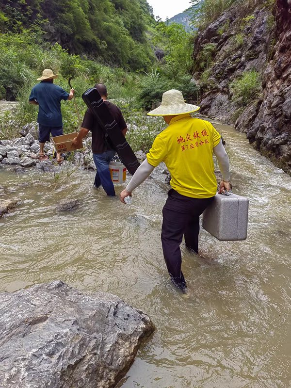 《跋山涉水  調(diào)查險(xiǎn)情》。7月上旬，重慶地質(zhì)礦產(chǎn)研究院駐守地質(zhì)工程師葉兆榮（右），攜帶地質(zhì)調(diào)查航拍設(shè)備，前往巫山縣兩坪鄉(xiāng)開(kāi)展三峽庫(kù)區(qū)重大危巖崩塌隱患調(diào)查。鄧朝松攝