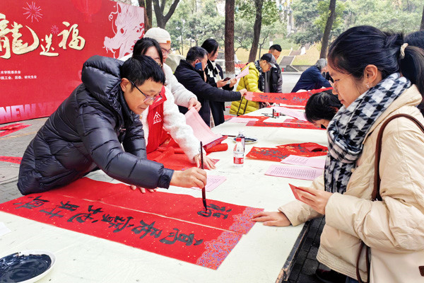 教師揮毫寫春聯(lián)。袁杰攝