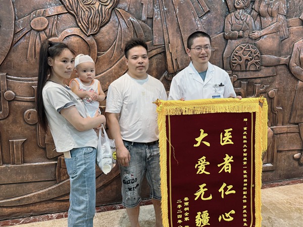 蔡忠?guī)е迌?，為羅醫(yī)生送來錦旗。朱雋攝