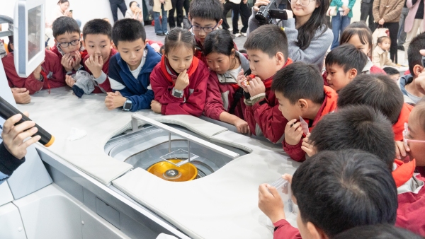 學(xué)生觀察海扶刀設(shè)備在玻璃片上打字。巴南區(qū)融匯小學(xué)供圖