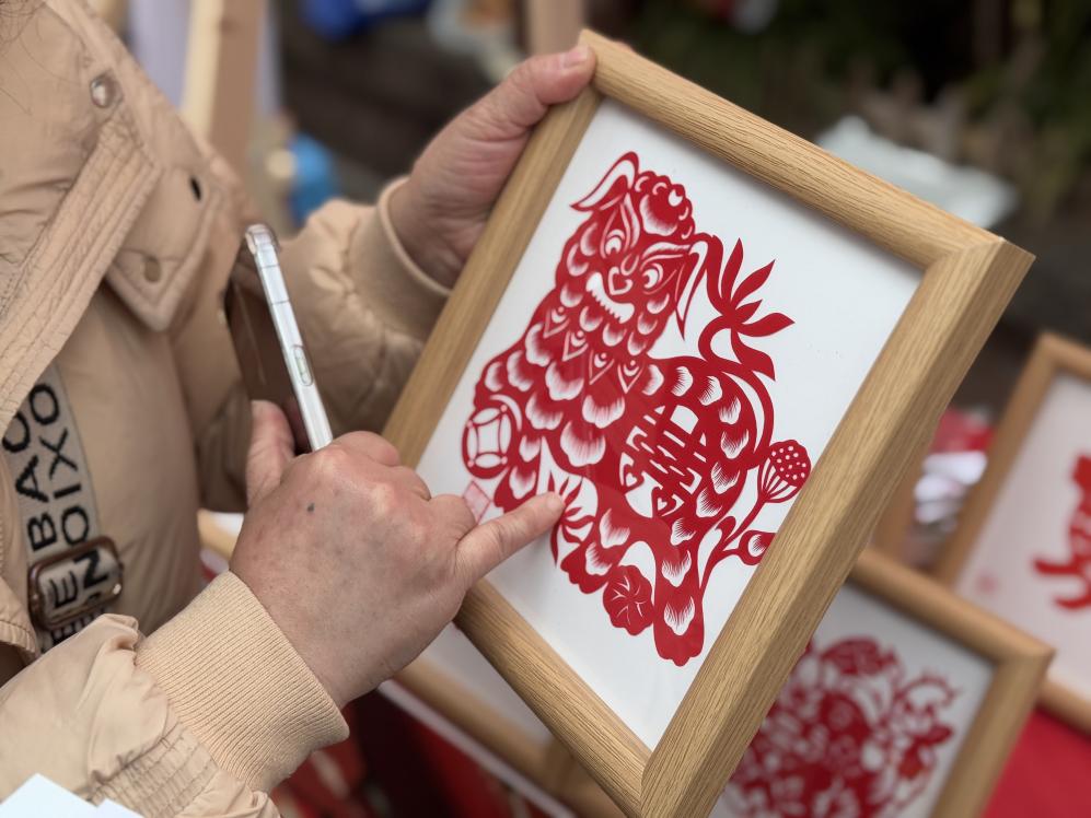 袁誼介紹自己的剪紙作品。黃亞輝攝