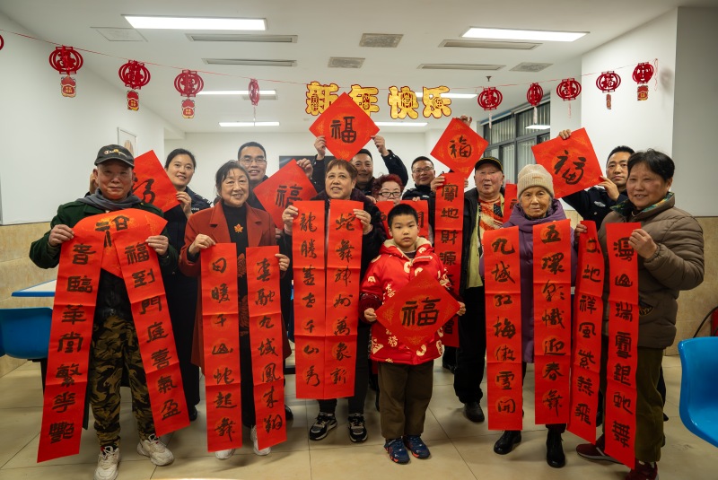 民警現(xiàn)場寫春聯(lián)送給居民。渝中區(qū)公安分局供圖