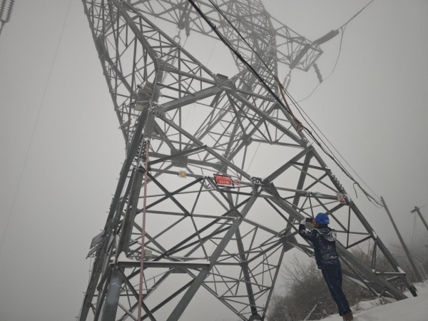 3月28日，國(guó)網(wǎng)城口供電公司輸電線路班鄧均華在三排山220千伏華城線237號(hào)塔觀察線路覆冰情況。王超攝