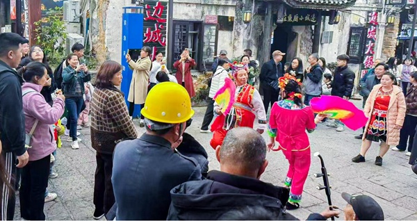 游客在洪安邊城旅游區(qū)觀看秀山花燈表演。姚華勝攝