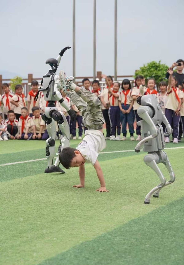 小朋友與機器人“斗舞”。甘國平攝