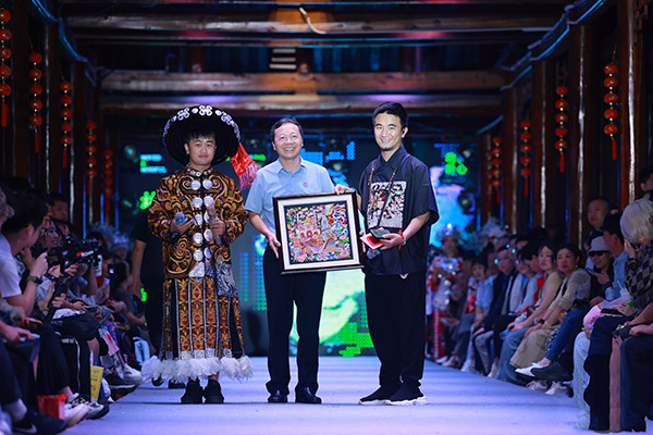 貴州村T發(fā)起人古阿新向重慶師范大學(xué)贈送禮物。主辦方供圖