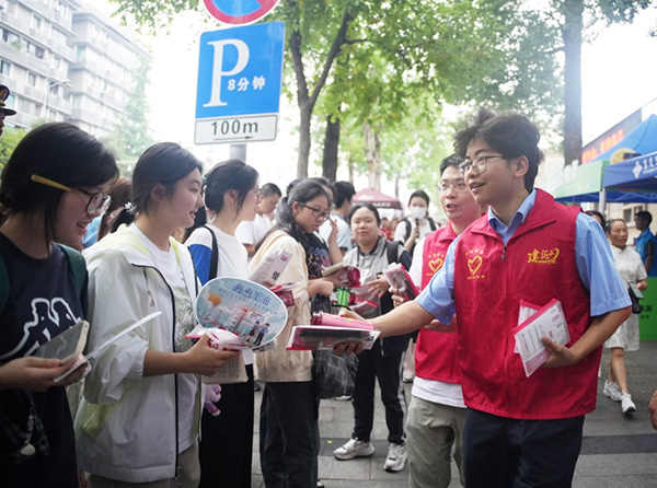 志愿者們?yōu)榭忌图议L送去祝福。活動主辦方供圖