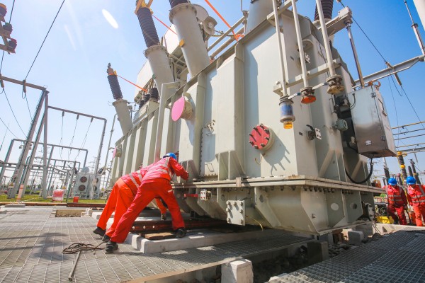 施工人員在220千伏田家變電站整體搬運(yùn)2號(hào)新主變壓器。蔣佩攝