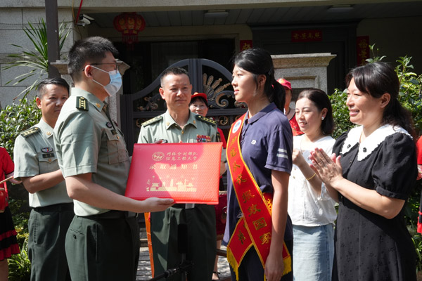 網(wǎng)絡空間部隊信息工程大學代表向付思然頒發(fā)錄取通知書。唐文蕤攝