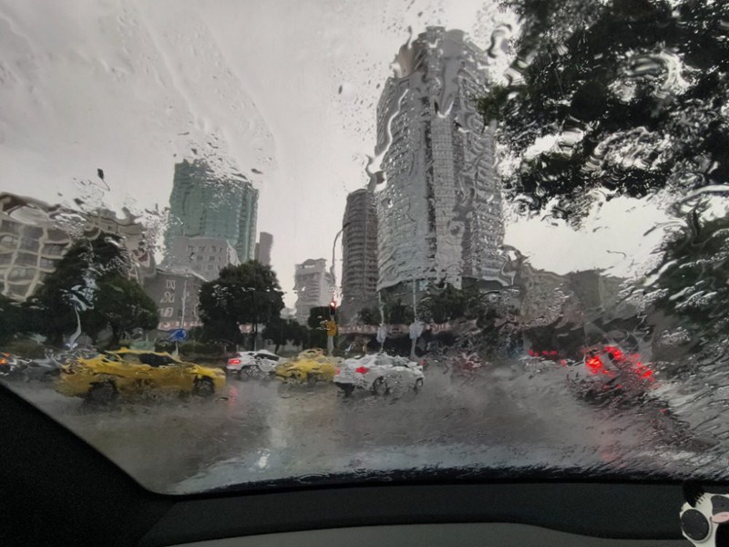 7月18日，渝中區(qū)中山四路旁環(huán)道，擋風(fēng)玻璃被雨水浸潤，模糊了周圍建筑。記者 謝智強(qiáng) 攝