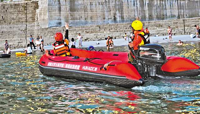 七月三十一日晚，方舟救援隊隊員駕沖鋒舟示意市民回到岸邊。記者 張錦輝 攝\視覺重慶
