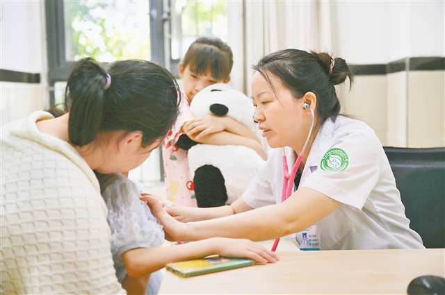 賀良萍正在為兒童患者看診，她準(zhǔn)備了熊貓玩偶幫助孩子克服恐懼。
