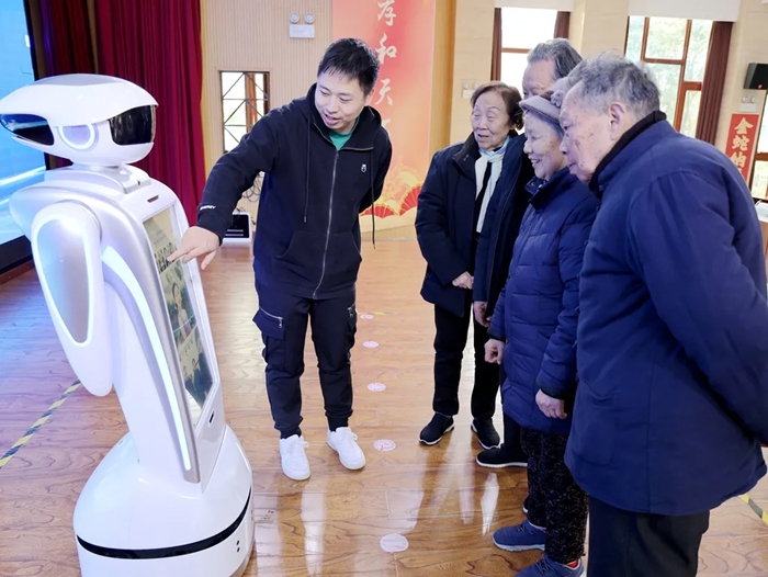 老人們與機(jī)器人“裴裴”互動(dòng)。重慶市第一社會(huì)福利院供圖